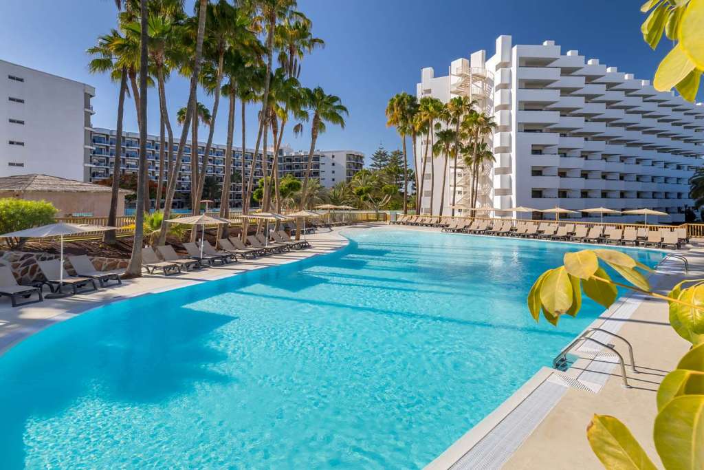A palm-lined hotel pool in Gran Canaria, Spain